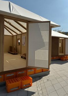 the inside of a building with several orange boxes in front of it and an open door