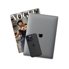 an ipad and magazine sitting next to each other