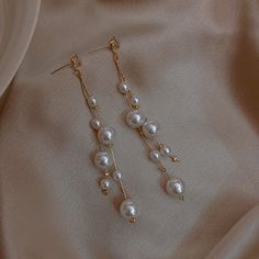 Pearl Dangle Earrings Take a look at our beautiful pearl earring design. These pearl drop earrings have been designed by a nature-originated jewelry designer and are made with faux pearls to give you an affordable and vintage style. Made with shell pearls and silver pins, these pearl earrings are easy to care for and will take your look from casual to formal in an instant. Product Specifications Pearl Type Shell Pearl Pearl Shape Round Pearl Size 6mm / 0.23 inches Length 50mm / 1.96 inches Pearl