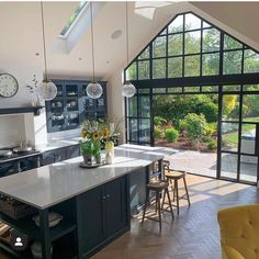 an open kitchen and living room with large windows