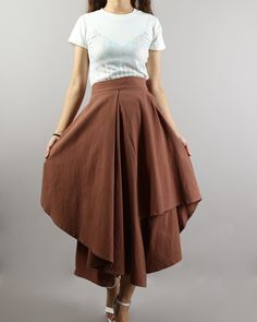 * A cropped pants, wide leg and fashion style. * Asymmetrical hem, and made of linen, two layers, outer layer is skirt, inner layer is pants. * With one pocket on the right side. * Materials: 50% cotton, 50% linen Shop sizing chart FYI ( actual body figures, not laying flat clothes measurements) Size XS (US 2, UK 6, German 32, French 34) Bust: fits bust around 33.5 inches/85cm Waist: fits waist around 26 inches/66cm Hips: fits hips around 36 inches/91cm Size S (US 6, UK 10, German 36, French 38) Hidden Pants Skirt, Relaxed Long Skirt With Layered Hem, Flowy Asymmetrical Skirt With Layered Hem, Brown Fitted Bottoms With Asymmetrical Hem, Linen Bottoms With Asymmetrical Hem For Summer, Casual Cotton Bottoms With Handkerchief Hem, Summer Linen Bottoms With Asymmetrical Hem, Cotton Asymmetrical Flowy Skirt, Fitted Bottoms With Layered Asymmetrical Hem