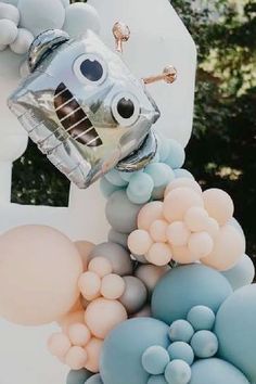 a bunch of balloons that are in the shape of a robot with eyes and nose