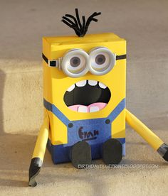 a yellow and blue paper toy with googly eyes