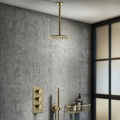 a shower head and hand shower faucet in a bathroom with grey wallpaper