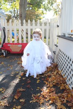 No sew toddler ghost costume: Use white turtle neck and your own pants, cut a hole into a white cotton fabric/sheet, layer over top of turtle neck (you may want to do a few stitches at the shoulders so it stays up), repeat with white tulle, rip or cut fabric/tulle into strips from bottom up, use one of the strips to tie a chain across the body. We had a chain piece left over from hanging a swing in the backyard. Diy Kids Ghost Costume, Kids Ghost Costume, Spiritual Holidays, White Turtle Neck