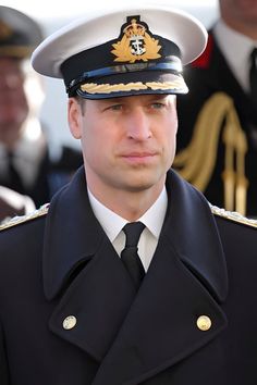 a man in uniform is looking at the camera