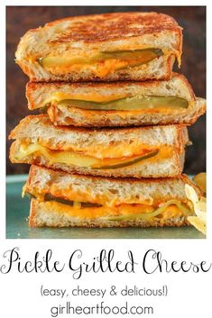 four grilled cheese sandwiches stacked on top of each other with pickles in the middle