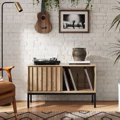 a living room with white brick walls and wooden furniture, including an old record player