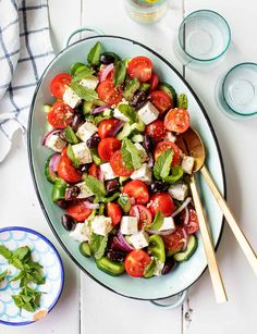 a salad with olives, tomatoes and mozzarella