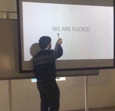 a man standing in front of a projection screen