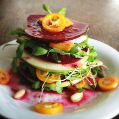 a white plate topped with fruit and veggies