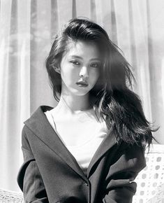 black and white photograph of a woman sitting on a couch