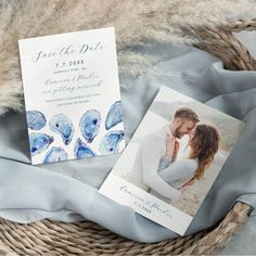 a wedding card and save the date photo on a blanket next to a wicker basket