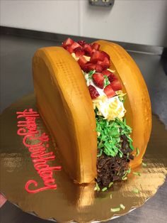 a cake made to look like a banana with strawberries and other toppings on it