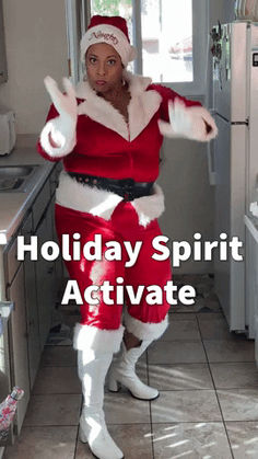 a man dressed as santa clause standing in a kitchen with the words holiday spirit activate