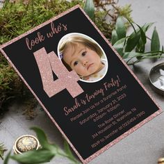 a pink and black birthday card with the number four on it, surrounded by greenery