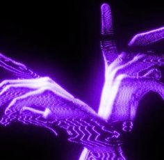 two hands are touching each other with their fingers in the air and glowing purple lights