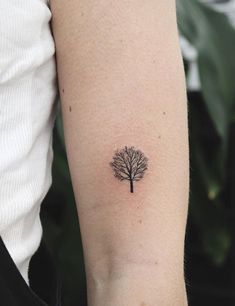 a small tree tattoo on the arm