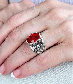 "The sterling silver filigree cocktail ring is a large size and features a lab created ruby gemstone set in an oxidized sterling silver filigree design. The ring has a wonderful filigree pattern that goes all the way around the face of the ring. We used the finest workmanship to create this beautiful cocktail ring which makes it unique and fun to wear. This beautifully crafted blue stone sterling silver cocktail ring will make you feel special when you wear it because it looks so classy and eleg Ruby Filigree Ring With Gemstone For Gift, Ruby Ring With Filigree For Gift, Ruby Ring With Filigree Detail As Gift, Ruby Ring With Filigree As Gift, Luxury Ruby Ring With Intricate Design For Gift, Luxury Ruby Ring With Intricate Design As Gift, Silver Ruby Filigree Ring, Ruby Filigree Ring For Gift, Ruby Filigree Ring With Intricate Design As Gift