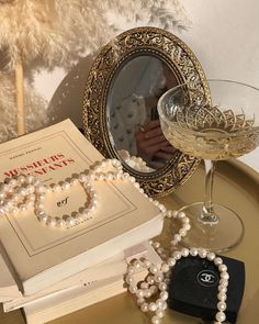 a table topped with pearls and a book