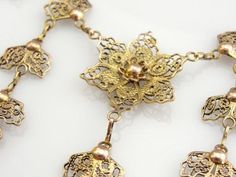 This is an outstanding filigree festoon necklace from the mid-1900's, a fine gold piece in excellent condition. Called 'quilling' this style of filigree work originated in the Middle East, Spain and Portugal. This pretty piece is suitable for day or night time wear, be it with a simple blouse or an elegant evening gown! Metal: 10K Yellow and Rose Gold Width: 2.5 inches Length: 17 inches Elegant Evening Gown, Festoon Necklace, Vintage Inspired Jewelry, Evening Gowns Elegant, Simple Blouse, Gold Piece, Spain And Portugal, Gold Filigree, The Middle East