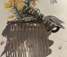 This is a unique handmade hair accessory, made from an original vintage silver tone, bow spray brooch, set with sparkling marcasites. These style brooches were popular in the 1930's, 1940's, 1950's and onward. The brooch pin is still intact and has been wired onto the hair comb, so that you could remove and wear again as a brooch if you wish. Approximate measurements Brooch length 2 inches / 5cm Comb width widest point 2.5 inches/ 6.5cm Total height of comb to the top of the bow  2 1/4 inches/ 5.5cm This item comes complete with a display box Marcasite Bracelet, Prom Hair Accessories, Marcasite Earrings, Hair Accessories Vintage, Bridal Jewelry Vintage, Marcasite Jewelry, Vintage Hair Combs, Vintage Hair Accessories, Handmade Hair Accessories