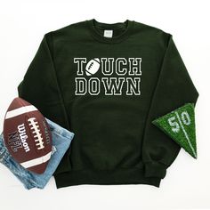 Touch Down on front of sweatshirt. Graphic color varies for sweatshirt. Adult Sizes S-XXL (unisex sizing)Youth Sizes S-XL (unisex sizing) Sweatshirt colors vary. For all Touch Down Tees click here to view.For Touch Down Sweatshirts click here to view.Gildan 18000 Heavy Blend, Port & Co, Jerzzees (availability varies)50/50 cotton/polyesterClassic, unisex fit1x1 rib with spandex Varsity Font, Sporty Red Moisture-wicking Sweatshirt, Heather Grey Sweatshirt, Sweatshirt Colors, Sweatshirt Graphic, Touch Down, Camp Style, Diy Halloween Projects, Sewing Workshop