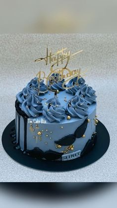 a birthday cake with blue frosting and gold sprinkles