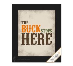 the buck stops here cross stitch pattern in black frame with orange, green and red lettering