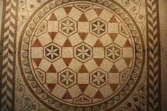 an intricately designed floor in the center of a room with many designs on it