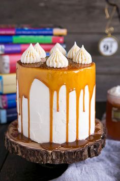 a cake with white frosting and caramel drizzled on the top