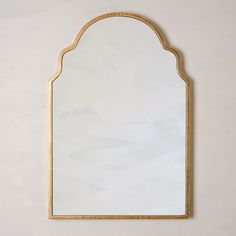 an arched mirror hanging on the wall