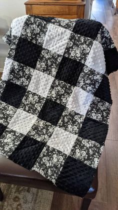 a black and white blanket sitting on top of a chair