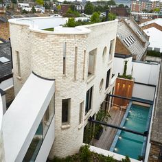 an aerial view of a house with a pool in the yard and rooftop garden area