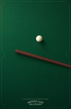 a billiard's cue and ball on a green pool table