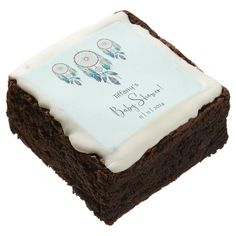 a brownie cake with white frosting and dream catchers on it's side