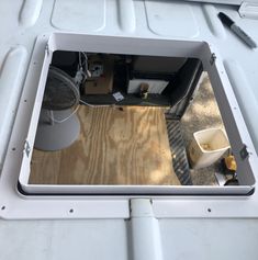 the inside of a white boat with a mirror on it's side and other items