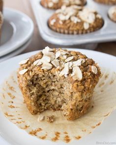 a muffin is sitting on a plate with some oatmeal toppings