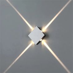 a square light fixture with three lights coming out of it's center and two rectangles in the middle