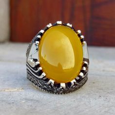 The ring is made of 925 sterling silver, decorated with stunning yellow zircon stone. PRODUCT FEATURES -Products are shipped with free shipping along with the box and bag. - Production Mine: 925 Sterling Silver - Weight: 15,5 grams - Stone: Yellow Zircon -Stone size: 15x20 mm All products come in a special gift box. If you don't see your size, please ask, we can produce your size. You are looking at high quality handcrafted silver ring. All our products are designed and produced by ourselves. Yo Luxury Handmade Yellow Rings, Mens Silver Rings, Men's Ring, Onyx Stone, Stone Ring, Stone Rings, Special Gifts, Onyx, Silver Ring