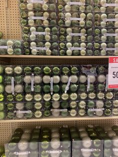 the shelves are filled with green and white items in plastic bins, labeled sale