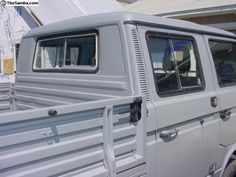 a silver truck parked in front of a house