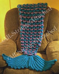 a crocheted mermaid tail blanket sitting on top of a chair