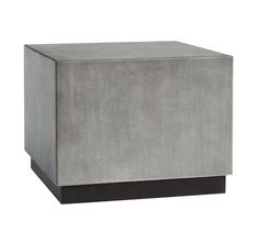 a grey concrete block with black legs and an end table in the middle, against a white background