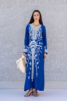 "**Note : The kaftan in the video is a different color of the exact same Kaftan and is only displayed to show the fit, flow, and cut of the Kaftan. You will receive the one in the pictures.** This beautiful Kaftan with the Siwa inspired embroidery is a bohemian and flashy dress that will catch everyone's eyes. it is a show stopper. This Kaftan is ideal to wear for any casual occasion. Whether taking a trip down the shopping lane, or home-based kitty parties, or about anything else, wearing this Traditional Blue Maxi Length Abaya, Traditional Blue Maxi Dress For Eid, Blue Dabka Maxi Length Abaya, Blue Traditional Abaya For Eid, Traditional Blue Abaya For Eid, Blue Embroidered Long Abaya, Traditional Blue Embroidered V-neck Dress, Embroidered Blue Long Sleeve Abaya, Blue Maxi Kaftan With Dabka Detail