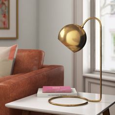 a living room scene with focus on the table lamp and books sitting on the coffee table