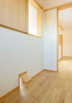 an empty room with wooden floors and white walls