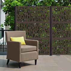 a brown chair sitting on top of a tile floor next to a wooden privacy fence