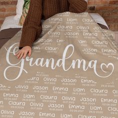 a woman covering her face with a blanket that says grandma on it and surrounded by words