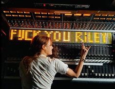 a woman standing in front of a sound board